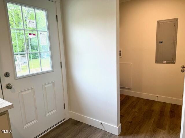 entryway with dark wood-style flooring, electric panel, and baseboards