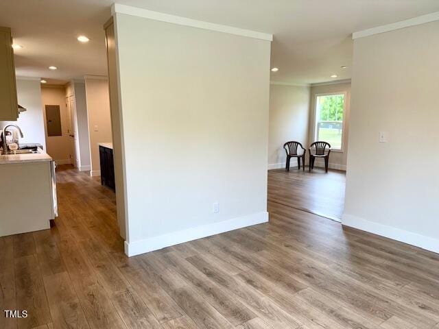 empty room featuring baseboards, ornamental molding, and wood finished floors