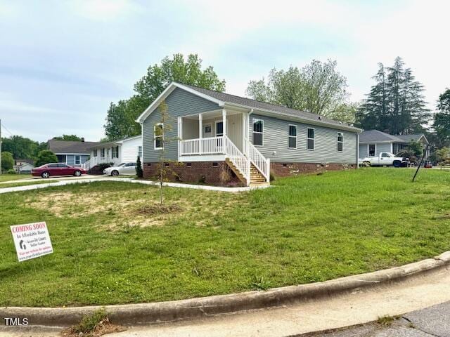 view of front of property with a porch, a front lawn, and crawl space