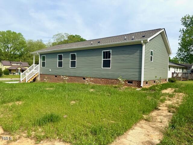 rear view of property featuring crawl space