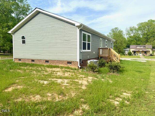 view of property exterior with cooling unit, crawl space, and a yard
