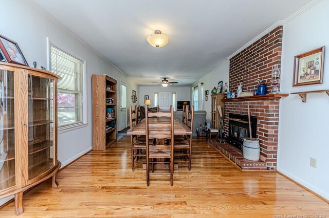 dining area with ornamental molding and light wood-type flooring