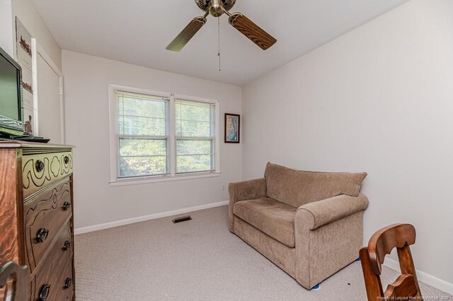 sitting room with carpet, visible vents, ceiling fan, and baseboards