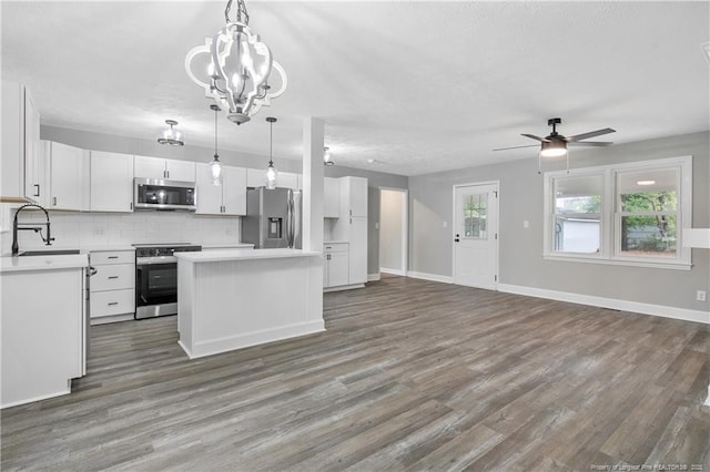 1833 Faber St, Fayetteville, NC 28304 - kitchen featuring white cabinets, a sink, appliances with stainless steel finishes, a kitchen island, and open floor plan