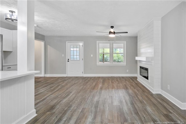 1833 Faber St, Fayetteville, NC 28304 - unfurnished living room with dark wood finished floors, a ceiling fan, and a fireplace