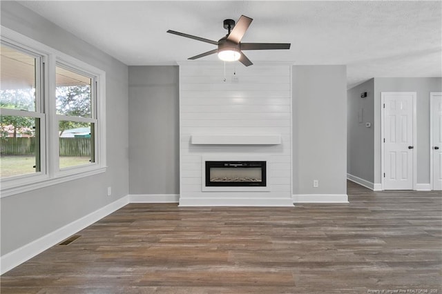 1833 Faber St, Fayetteville, NC 28304 - unfurnished living room with a fireplace, wood finished floors, a ceiling fan, and baseboards