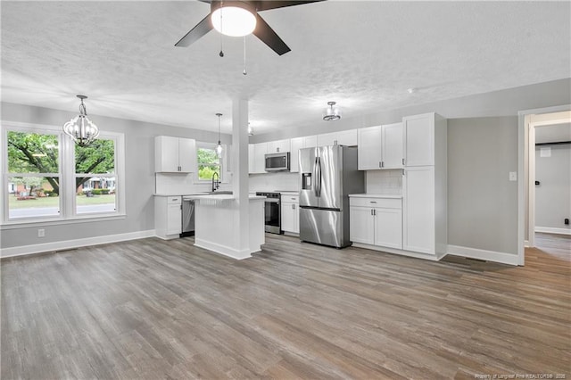 1833 Faber St, Fayetteville, NC 28304 - kitchen with a sink, baseboards, appliances with stainless steel finishes, and ceiling fan with notable chandelier