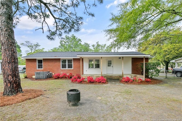 1833 Faber St, Fayetteville, NC 28304 - back of house featuring a porch, brick siding, and central AC unit