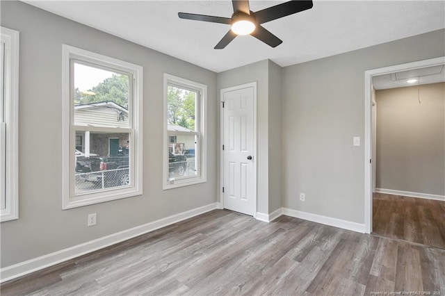 1833 Faber St, Fayetteville, NC 28304 - unfurnished bedroom with attic access, wood finished floors, and a ceiling fan