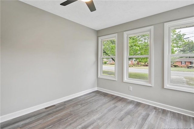 1833 Faber St, Fayetteville, NC 28304 - spare room featuring wood finished floors, healthy amount of natural light, and a ceiling fan