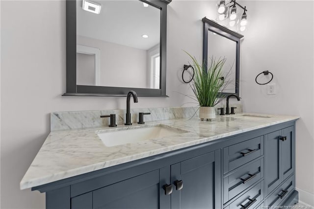 bathroom with double vanity, a sink, and visible vents