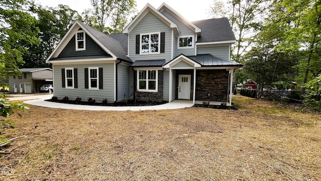 craftsman-style house with stone siding and roof with shingles