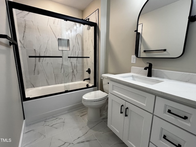 bathroom with vanity, marble finish floor, enclosed tub / shower combo, and toilet