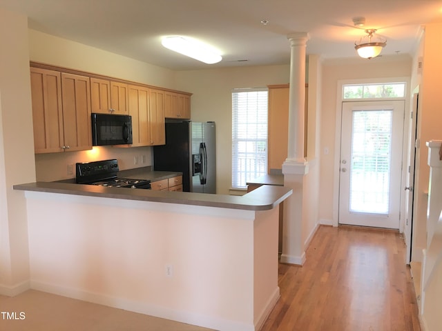 113 Conner Dv Unit 106, Chapel Hill, NC 27514 - kitchen featuring decorative columns, a peninsula, baseboards, light wood-type flooring, and black appliances