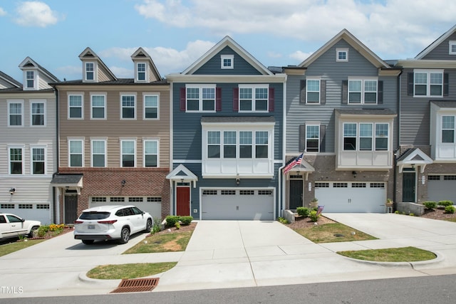 multi unit property featuring a garage and driveway