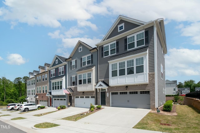 multi unit property with brick siding, a garage, driveway, and a residential view