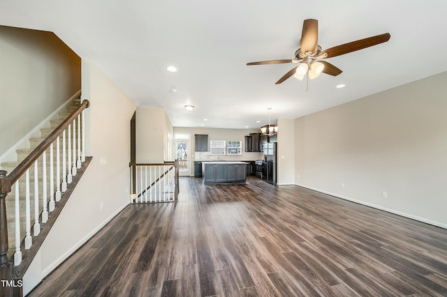 unfurnished living room with recessed lighting, baseboards, a ceiling fan, and dark wood finished floors