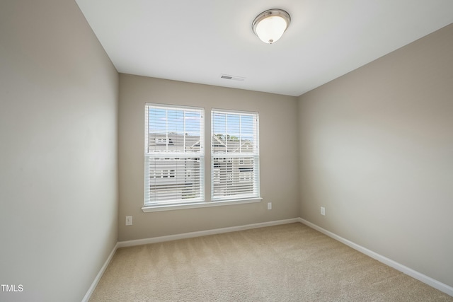 unfurnished room featuring baseboards, carpet flooring, and visible vents