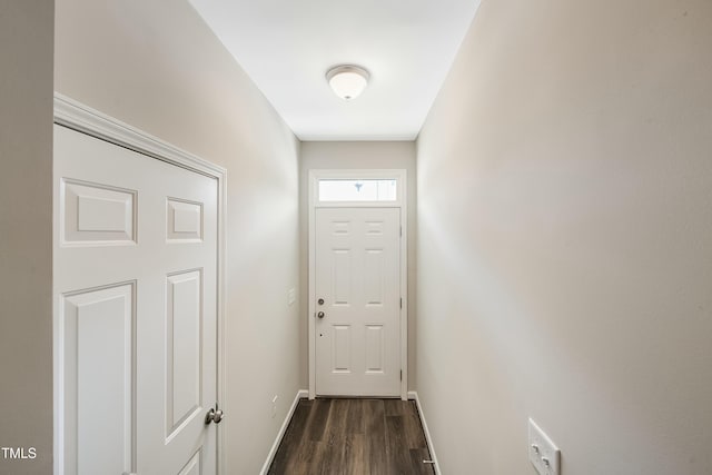 doorway to outside with dark wood-style flooring and baseboards