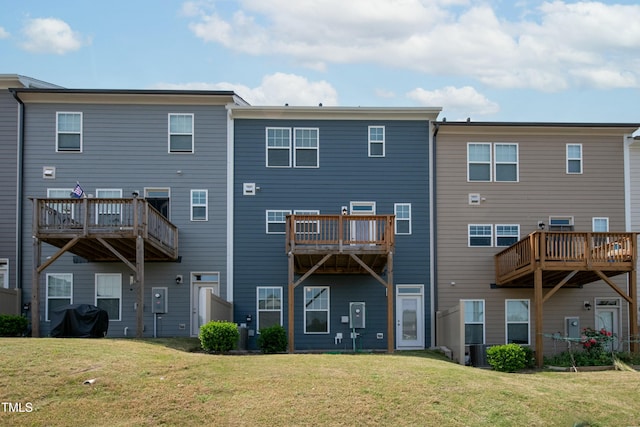 rear view of property featuring a lawn