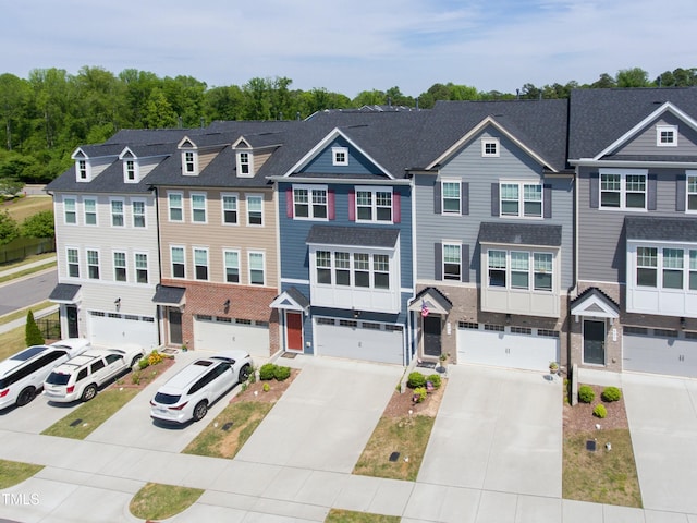 townhome / multi-family property featuring a garage and driveway
