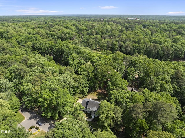 aerial view featuring a wooded view