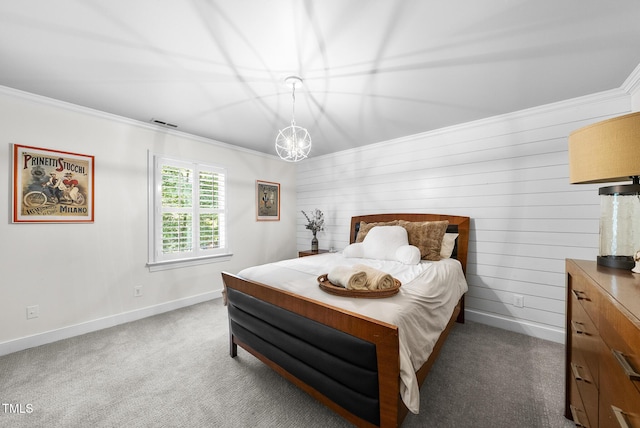 carpeted bedroom featuring baseboards, ornamental molding, and visible vents