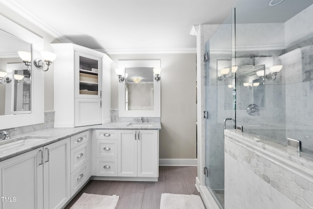full bath featuring crown molding, wood finished floors, vanity, and a shower stall