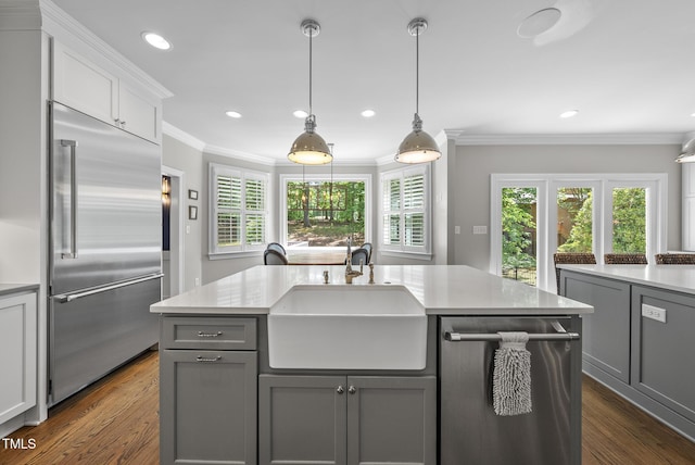 kitchen with light countertops, a sink, gray cabinetry, and stainless steel appliances