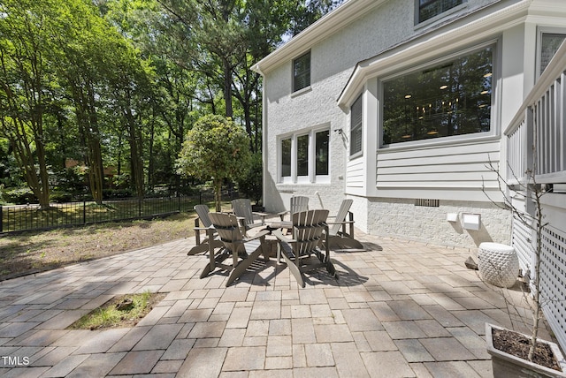view of patio featuring fence and outdoor dining area