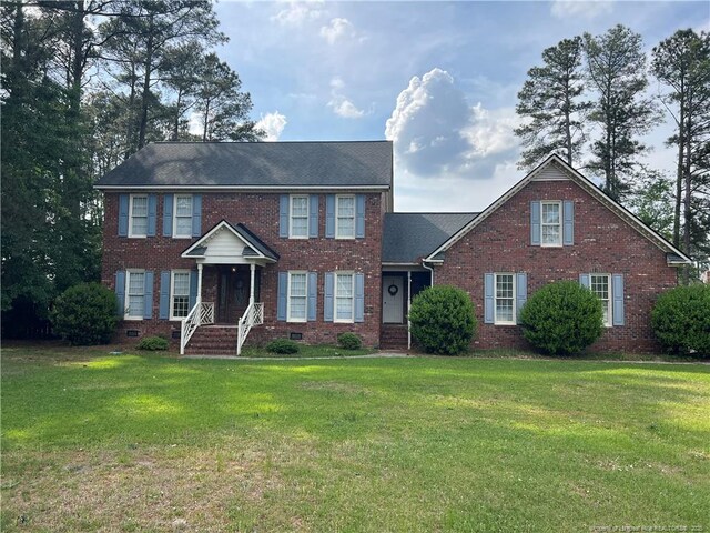 5400 Labrador Dr, Hope Mills, NC 28348 - colonial home featuring crawl space, brick siding, and a front yard