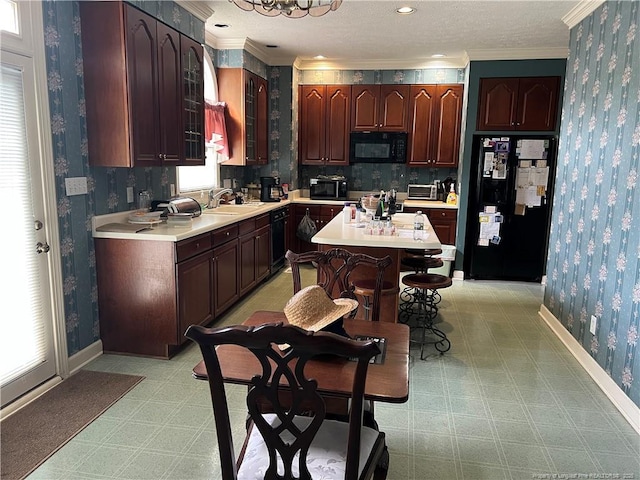 5400 Labrador Dr, Hope Mills, NC 28348 - kitchen with wallpapered walls, light floors, light countertops, and black appliances