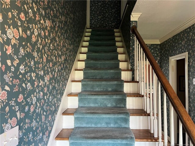 5400 Labrador Dr, Hope Mills, NC 28348 - stairway with ornamental molding, wallpapered walls, and wood finished floors