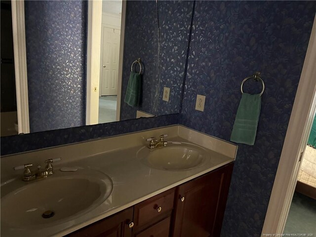 5400 Labrador Dr, Hope Mills, NC 28348 - bathroom with double vanity, wallpapered walls, and a sink