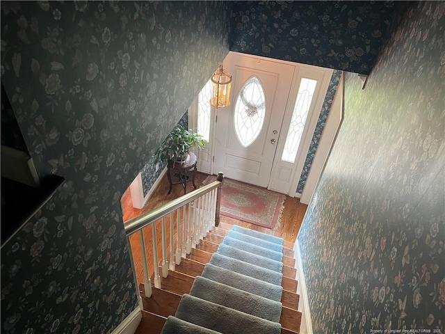 5400 Labrador Dr, Hope Mills, NC 28348 - entrance foyer with stairs, baseboards, wallpapered walls, and wood finished floors