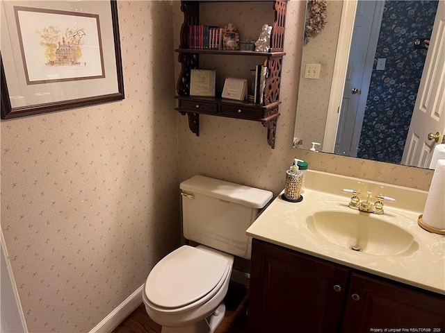 5400 Labrador Dr, Hope Mills, NC 28348 - bathroom with toilet, vanity, and wallpapered walls