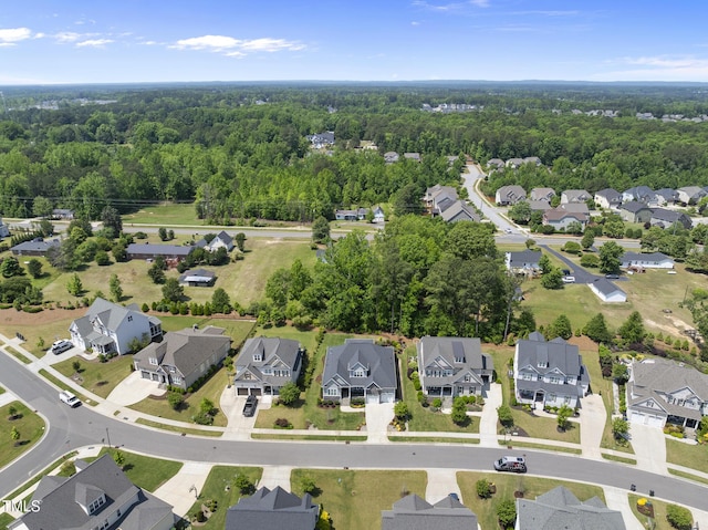 drone / aerial view with a residential view and a wooded view