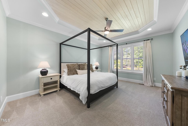bedroom with carpet, baseboards, wooden ceiling, a tray ceiling, and ornamental molding