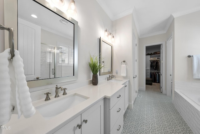 full bathroom featuring a shower stall, double vanity, ornamental molding, and a sink