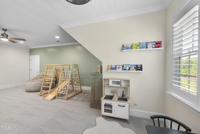 playroom with crown molding, baseboards, a ceiling fan, and a healthy amount of sunlight