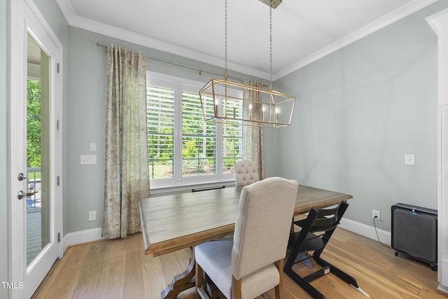 dining space with a wealth of natural light, ornamental molding, and a chandelier