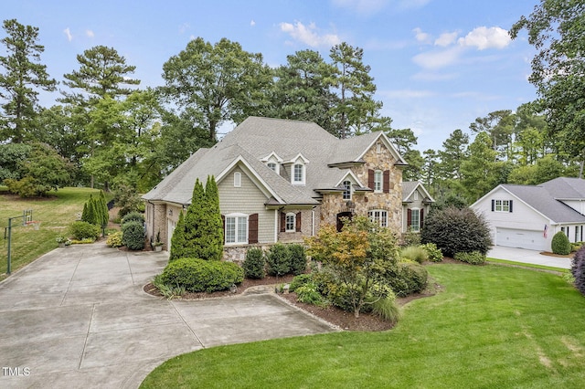 1605 Hunting Ridge Rd, Raleigh, NC 27615 - craftsman-style home featuring driveway, stone siding, and a front lawn