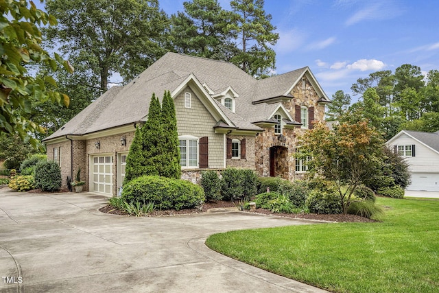 1605 Hunting Ridge Rd, Raleigh, NC 27615 - view of front of home with roof with shingles, concrete driveway, a front lawn, and stone siding
