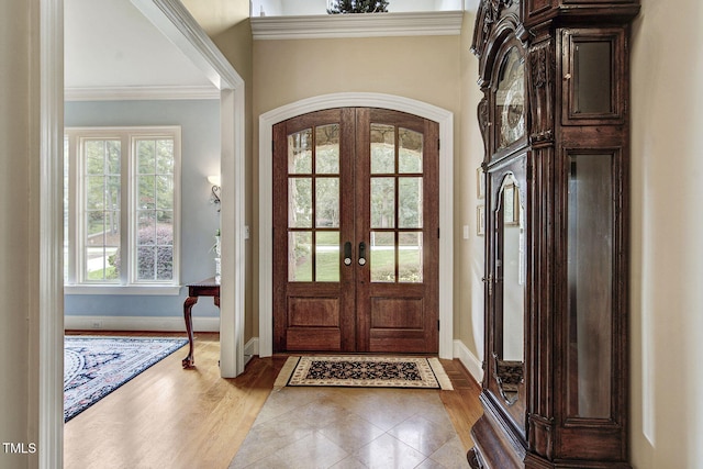 1605 Hunting Ridge Rd, Raleigh, NC 27615 - tiled foyer with french doors, crown molding, baseboards, and arched walkways