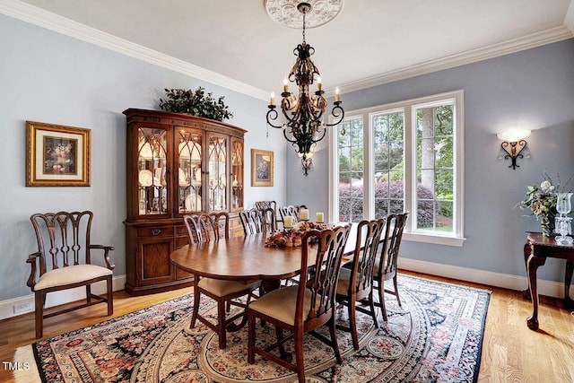 1605 Hunting Ridge Rd, Raleigh, NC 27615 - dining space with plenty of natural light, ornamental molding, and an inviting chandelier