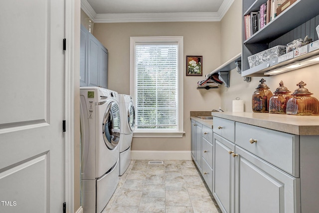 1605 Hunting Ridge Rd, Raleigh, NC 27615 - laundry room with baseboards, cabinet space, crown molding, and independent washer and dryer