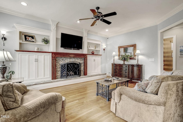 1605 Hunting Ridge Rd, Raleigh, NC 27615 - living room featuring a stone fireplace, wood finished floors, recessed lighting, and ceiling fan