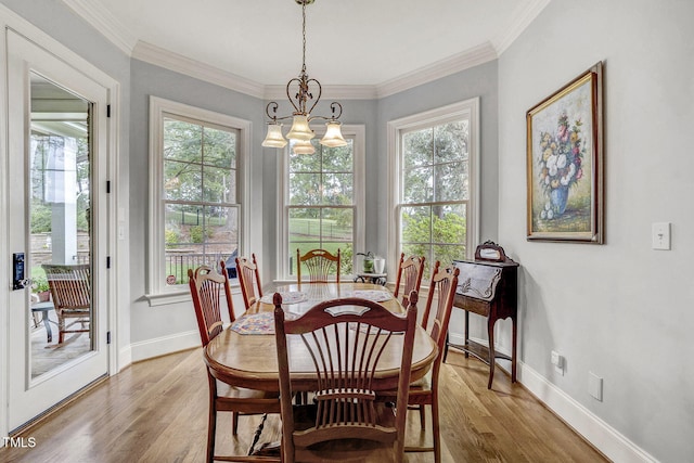 1605 Hunting Ridge Rd, Raleigh, NC 27615 - dining room featuring a wealth of natural light, light wood-type flooring, a notable chandelier, and baseboards