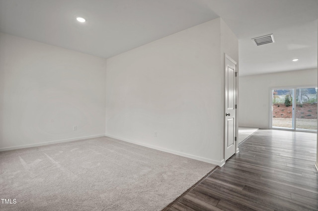 spare room with dark wood-style flooring, baseboards, and recessed lighting