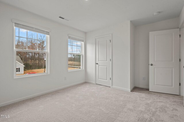 unfurnished bedroom with carpet flooring and baseboards